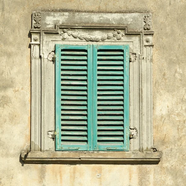 Красивые старые окна с зелеными ставнями — стоковое фото